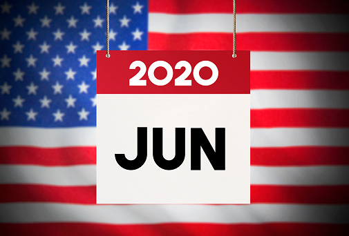 Calendar standing in front of the American flag and showing June 2020 Stock Image