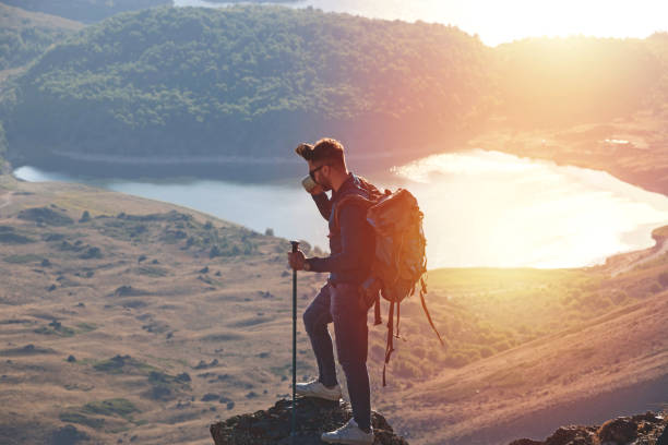 istock A man drinking a cup of tea on a stone 1175682115