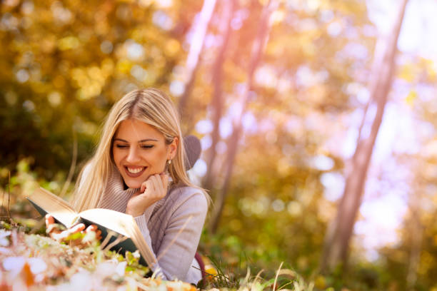 istock young blonde lying on a fallen autumn leaves 1175683659