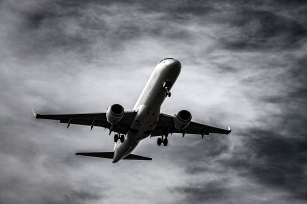 istock Airplane in front of dramatic sky 1175685161