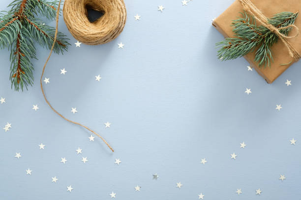 istock Christmas composition. Christmas frame made of fir tree branches, gift box, rope, confetti star on pastel blue background. Flat lay, top view, copy space. Christmas, New Year, winter holiday concept. 1175685707
