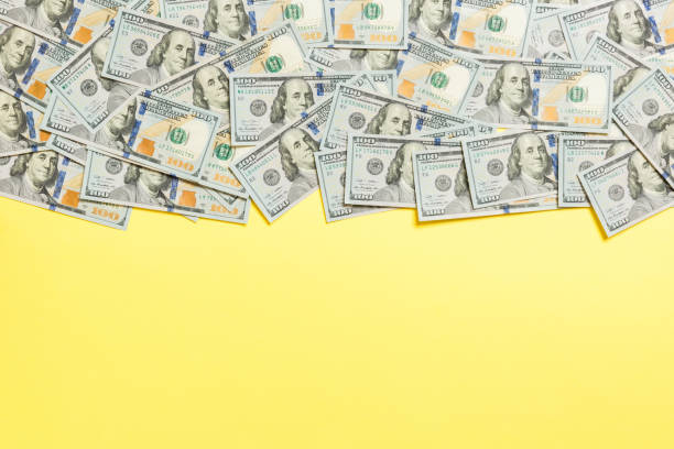 istock One hundred dollar banknotes on colored background top view, with empty place for your text business money concept. One hundred dollar background. 1175686032