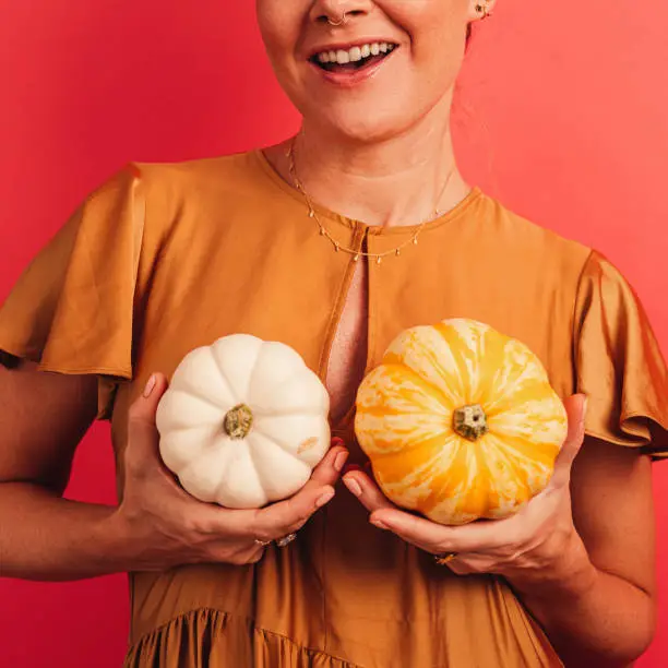 Woman with pumpkins infront of her breast
breast awareness and playful concept
Studio shot