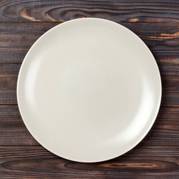 istock Top view with empty for you design. Empty white plate on wooden background 1175686377