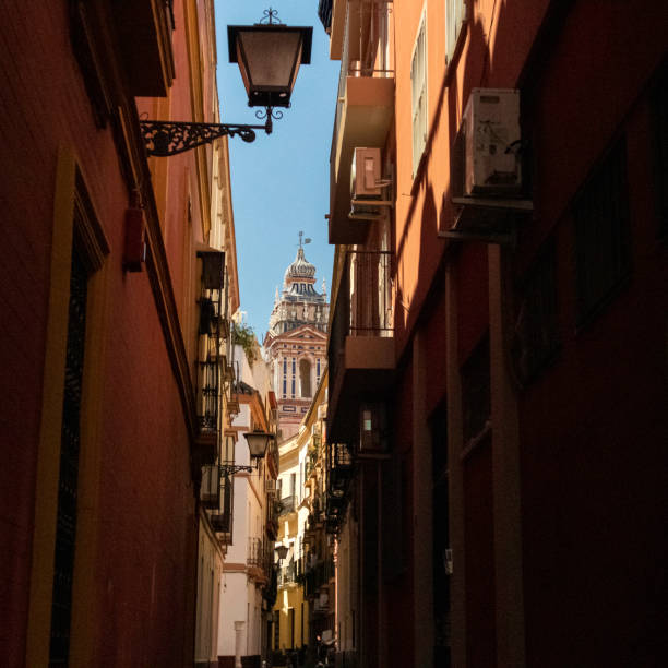 A view at the street with classical architecture of Seville in Spain.\nSeville, Spain - June 20, 2019