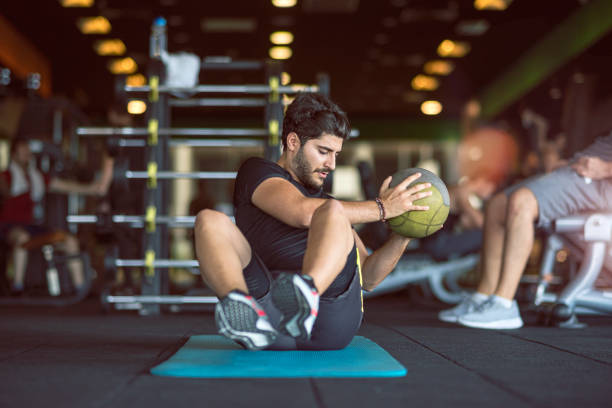 Man doing exercise with medicine ball Cross Training, Health Club, Gym, Exercising, Stretching turkey tattoo stock pictures, royalty-free photos & images