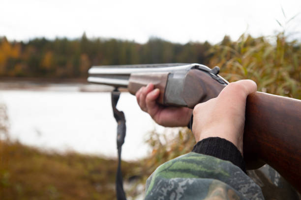 istock The man with the gun. A man and a double-barreled gun. 1175689638