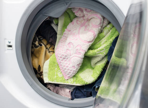 istock dirty laundry in the washing machine, close-up 1175689686