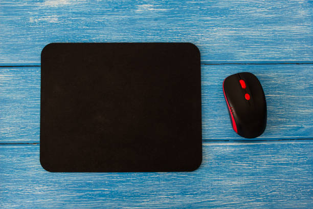 istock computer mouse pad and mouse on a blue wooden background 1175690396