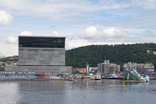 Oslo, Norway - June 26 2019: The Munch Museum at Bjørvika on the waterfront, next to the Oslo Opera House and She Lies.