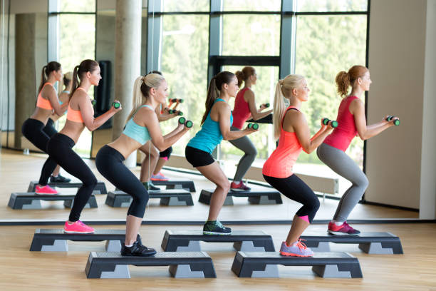 istock group of women with dumbbells and steppers 1175690875