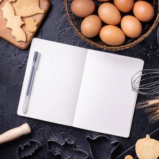 istock Making cookies cookbook recipe design concept, baking ingredients preparation layout with notebook. 1175691150