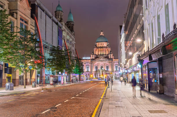 The Belfast City Hall at Donegall Square in Belfast, Northern Ireland at Night The Belfast City Hall from Donegall Pl in Belfast belfast stock pictures, royalty-free photos & images