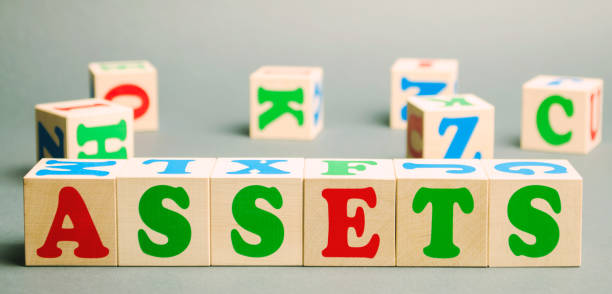 istock Wooden blocks with the word Assets and randomly scattered cubes. Resource owned by the business. Financial accounting. Money and finance. Cash equivalents, certificates of deposit 1175691491