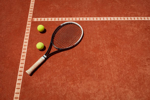 istock Tennis balls and racket on red dross 1175692344