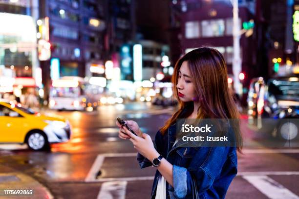 Woman Using Mobile Phone While Crossing Street Stock Photo - Download Image Now - 20-24 Years, Adult, Adults Only