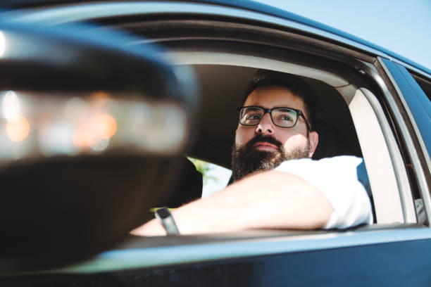 istock Elegant hipster with beard driving a car 1175693659