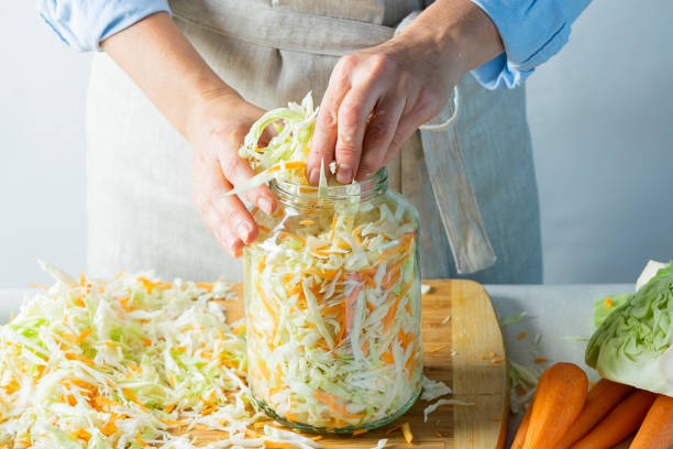 The preparation process fermentation preservation Sauerkraut on a light background. Natural rustic style. Canned food