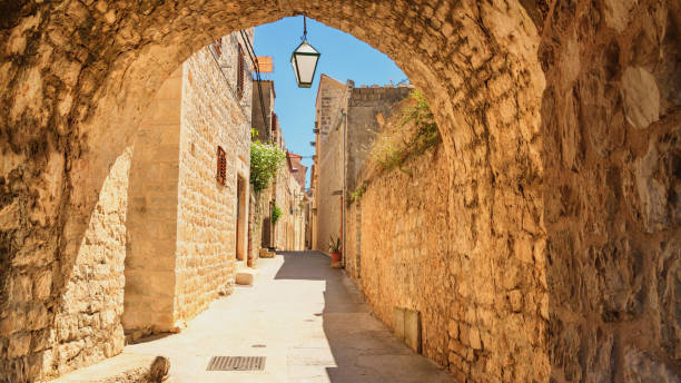 Mediterranean summer cityscape - view of a medieval street in the Old Town of Hvar Mediterranean summer cityscape - view of a medieval street in the Old Town of Hvar, on the island of Hvar, the Adriatic coast of Croatia hvar photos stock pictures, royalty-free photos & images