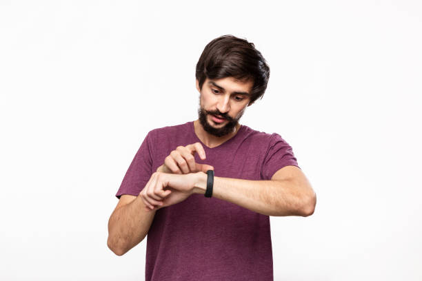 istock Handsome brunet bearded man with moustaches checking notification with smart watches. Using modern technologies in everyday life. 1175696014