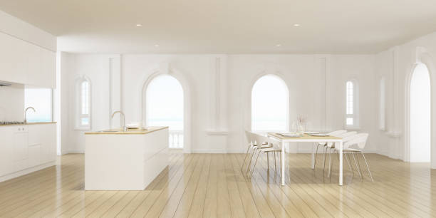 perspectiva de la sala de cocina de lujo con mesa de comedor y moderna isla laminada blanca en el fondo con vistas al mar, diseño de estilo interior clásico, renderizado 3d. - table chair white curve fotografías e imágenes de stock