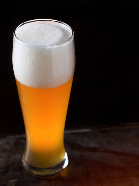 istock A glass of light beer on a dark background closeup 1175697591