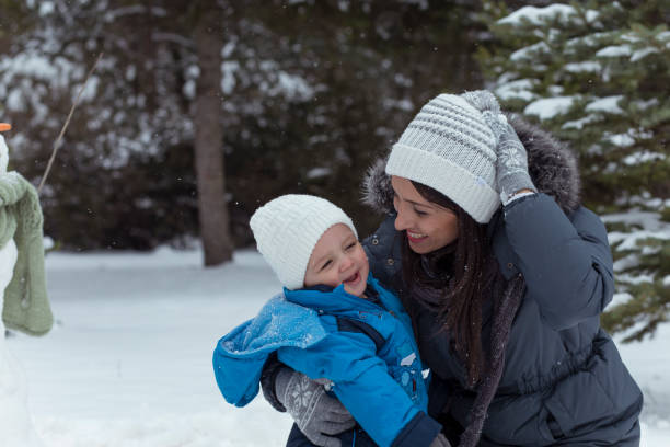 istock Happy family playing outside in snow 1175697642