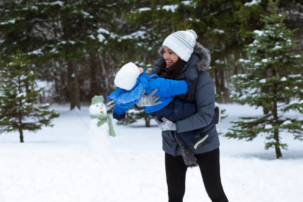 istock Happy family playing outside in snow 1175697657