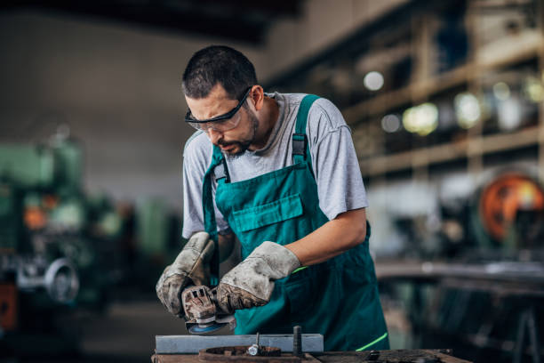istock Young guy grinding in factory workshop 1175698627