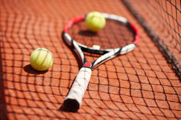 istock Tennis balls and racket on red dross 1175699317