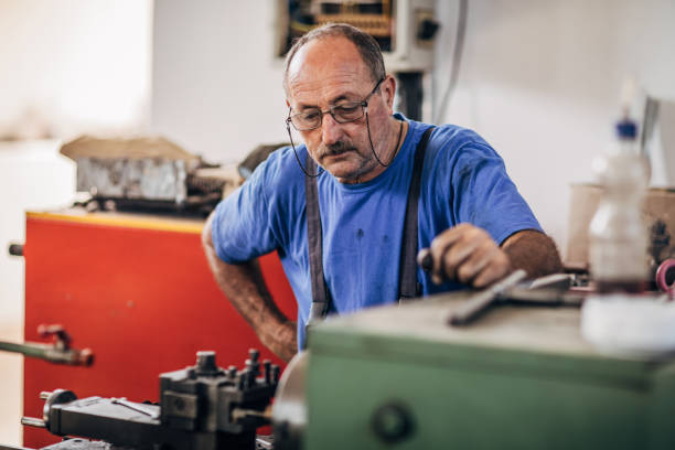 istock Man working on a factory machine 1175699373