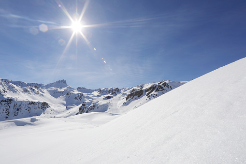 Mature woman skiing on ski slope in European Alps, Austria. \nSunny winter day.\nCanon R5