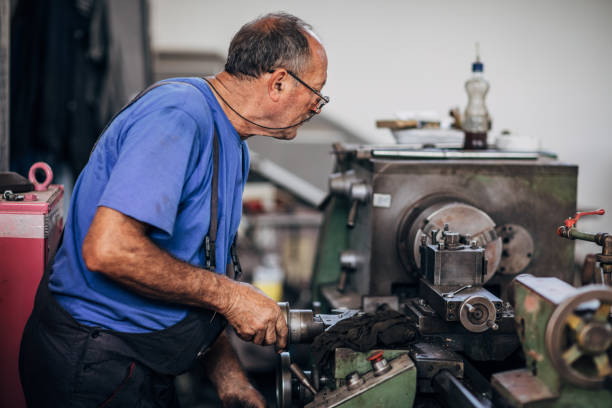 istock Manual worker working on a machine in factory alone 1175700229