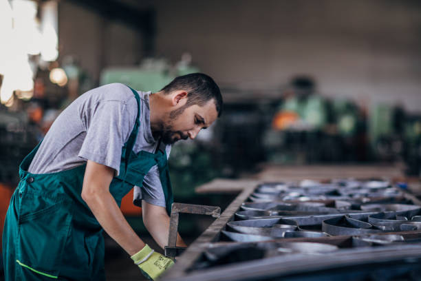 istock Young man working hard in factory workshop 1175700925