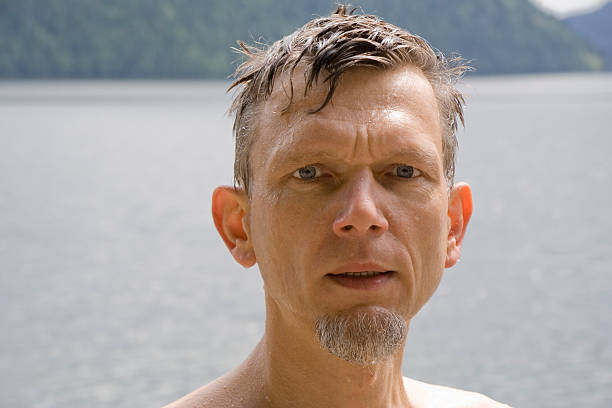 Wet mature man portrait - after swimming in cold Clearwater Lake, Wells Gray Provincial Park, British Columbia, Canada