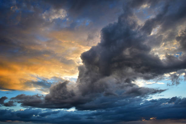 istock Storm clouds at sunset in orange and blue colors 1175701810