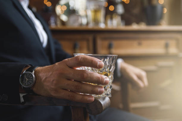 istock Male hand with a glass of expensive whiskey 1175702017