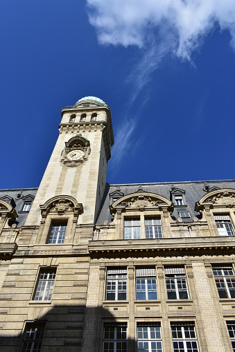 Latin Quarter, Paris, France. View of the Sorbonne College building with the Astronomy Tower with clock and green dome on a sunny day.