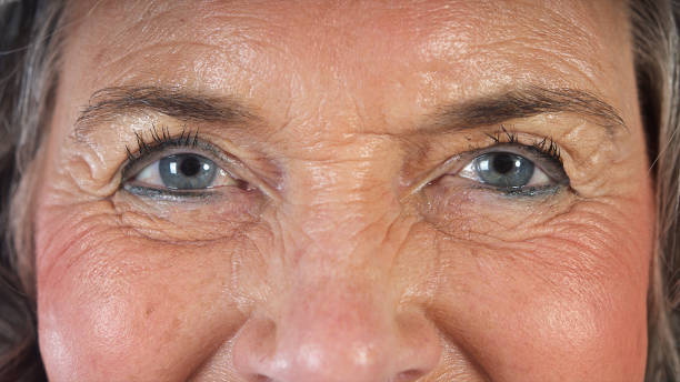 istock Close Up Smiling Senior Woman Eyes Front View 1175702499