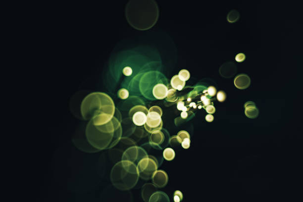 istock Beautiful optical abstract color bokeh in the darkness background. 1175703260