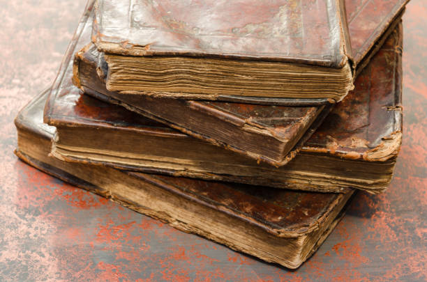 istock Stack of old and worn leather cover books with gold leaf embossing. Closeup 1175704886