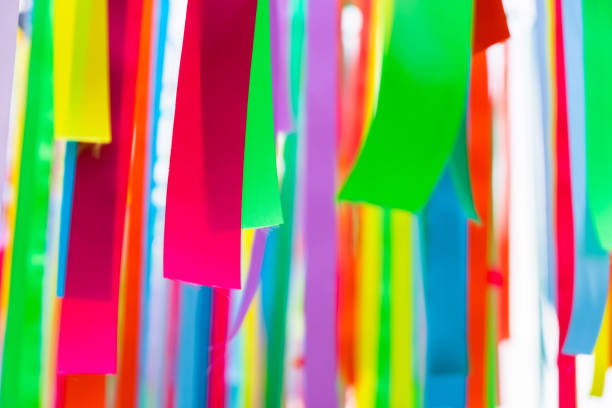 Closeup colorful ribbons hanging outdoor in the park as decoration for festive event, abstract colorful ribbons