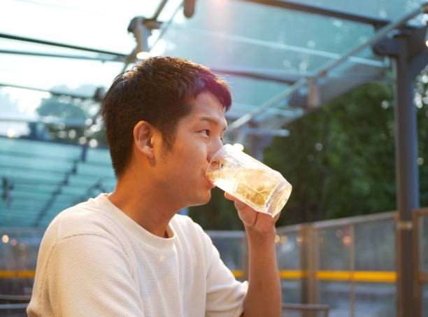 A Japanese man is drinking at a terrace seat.