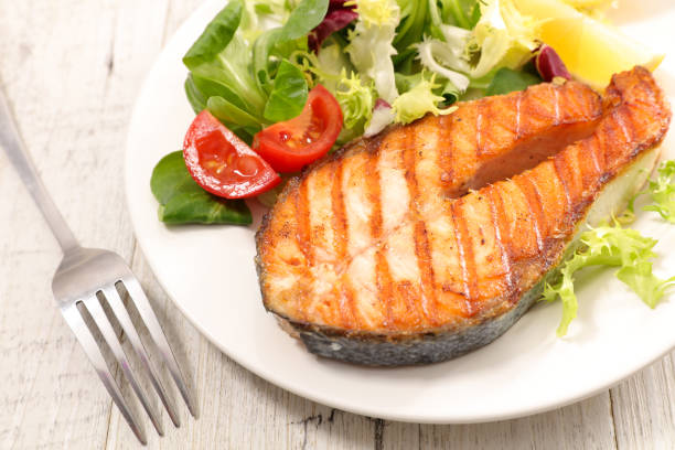 istock grilled salmon steak with salad 1175708163