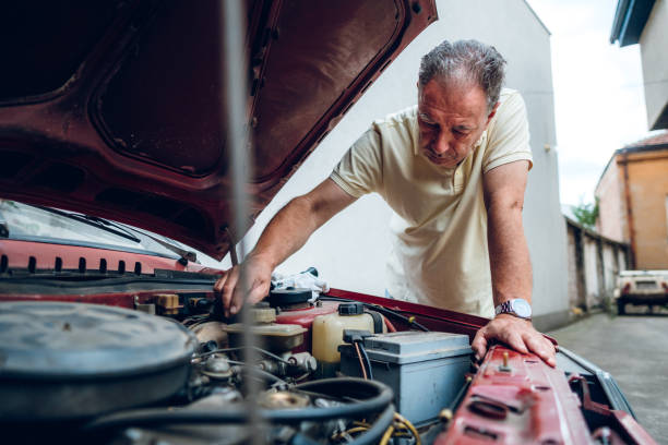 istock Senior man repairing car 1175708392