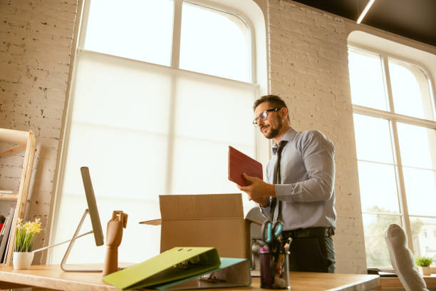 istock A young businessman moving in office, getting new work place 1175709514