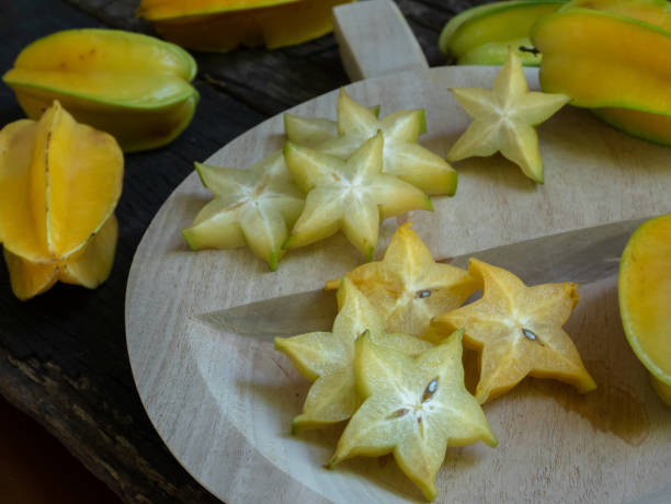 istock Fresh organic cut star fruit on wooden chopping board, copy space 1175710716