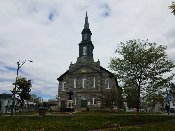 istock grey stone church with dandelions and grass 1175713283