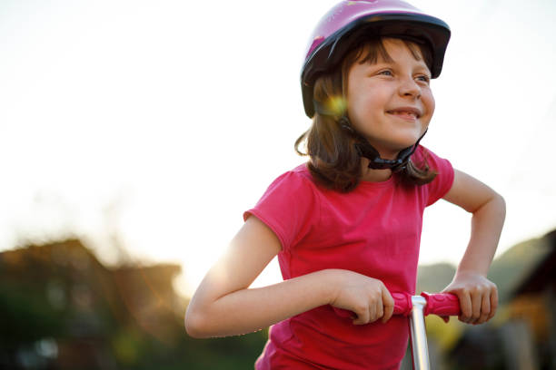 istock Cute happy girl riding push scooter 1175716953