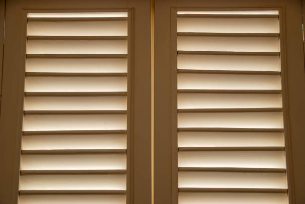 istock Light through wooden blind shutters in closed position. 1175718896